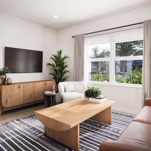 a living room with a tv, coffee table and couch